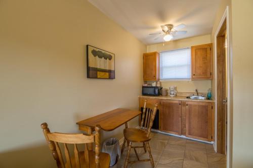 a kitchen with a table and chairs in a room at Alpine Motor Inn in Alma