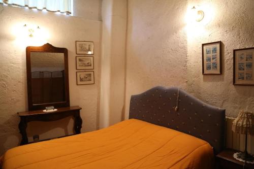a bedroom with a bed and a mirror at Ferienhaus in Camporgiano mit Grill und Terrasse in Poggio