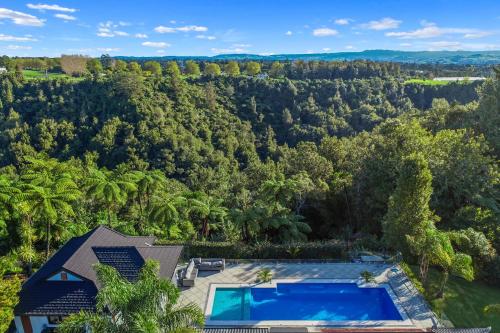 an aerial view of a house with a swimming pool and trees at Sanctuary Ridge in Tauranga