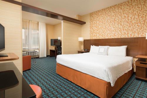 a hotel room with a bed and a flat screen tv at Fairfield by Marriott Inn & Suites Knoxville Turkey Creek in Knoxville