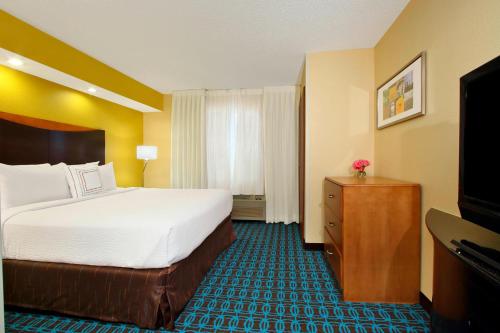 a hotel room with a bed and a television at Fairfield Inn & Suites Colorado Springs South in Colorado Springs