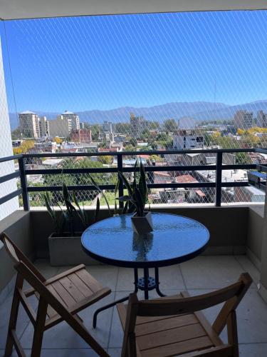 a blue table and two chairs on a balcony at Andes Suites Premium in Salta