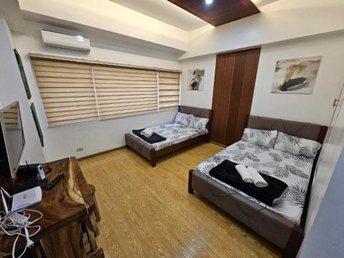 a living room with a bed and a couch at CedarPeak419 in Baguio