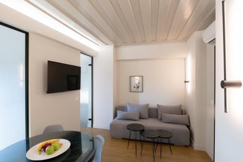 a living room with a couch and a table at Hanim Boutique Hotel in Chania Town