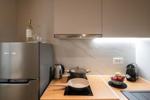 a kitchen with a refrigerator and a bowl of fruit on a counter at Hanim Boutique Hotel in Chania Town