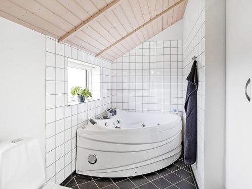 a white bathroom with a large tub in it at Holiday home Sydals XL in Neder Lysabild