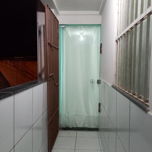 a shower stall with a shower curtain in a room at Apartamento temporada in Campina Grande