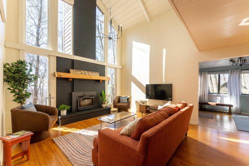 a living room with a couch and a fireplace at Leaf-Peeping at Oak Ledge! Trails,Tastings,Peace in Lyndhurst