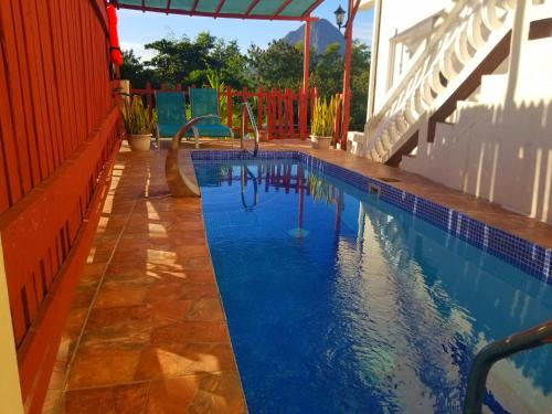 a swimming pool with a slide in the middle at Comfort Suites - Two Bedroom Apartment in Choiseul
