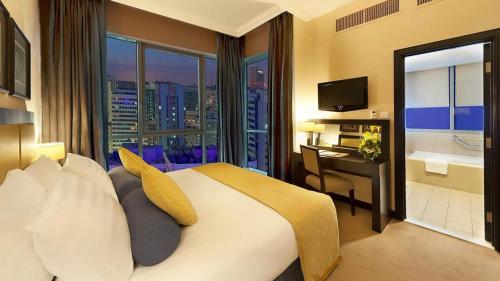 a bedroom with a large bed with a view of a city at ALMASSA FOR APARTMENTS in Kuwait