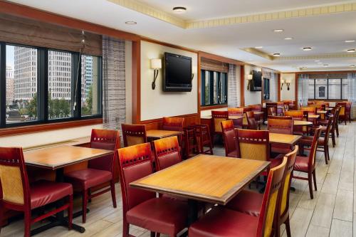 a restaurant with tables and chairs and a tv at Residence Inn by Marriott Philadelphia Center City in Philadelphia