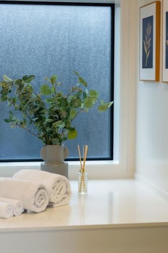 a bathroom counter with towels and a window at Prime Location: Hagley, Riverside, Hospital in Christchurch