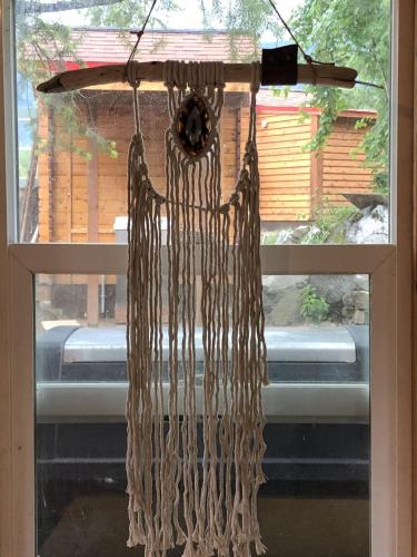 a bunch ofaments hanging from a window at Idyllic Cabin Retreat Only 5 Minutes Away From Nelson in Nelson