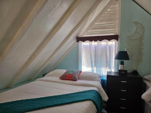 sypialnia z łóżkiem i oknem w obiekcie Memories by the Shore w Negril