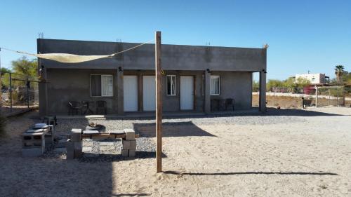 a building with a table and a pole in front of it at Baja's Rest Stop in San Felipe
