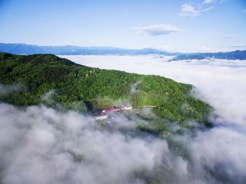 an island in the middle of a field of clouds at Ikoi no Mura Heritage Minoyama in Minano