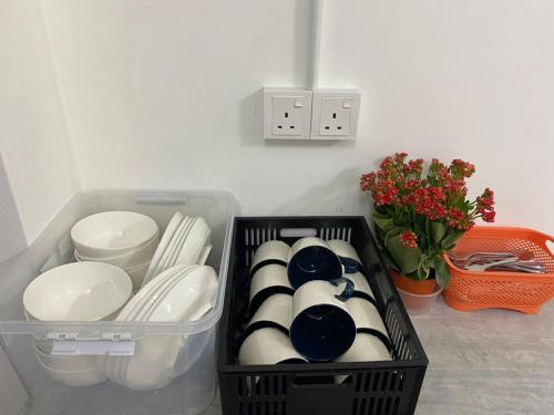 a black container filled with plates and bowls at SmileHome at Cameron Palas Horizon - KEA FARM in Brinchang