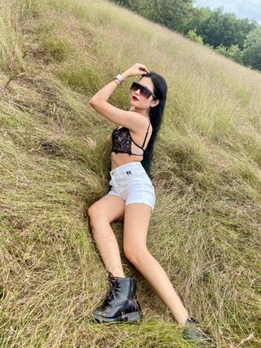 a woman laying in a field of grass at Damnak Borey Resort in Kampot