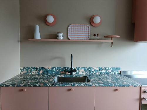 a kitchen with a sink and a counter top at Hieno kaksio keskustassa rauhallisella alueella in Lovisa