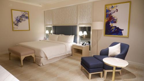 A bed or beds in a room at Royce Hotel & Casino