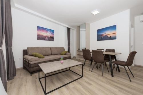 a living room with a couch and a table at Apartments Mari - 40m from the beach in Makarska