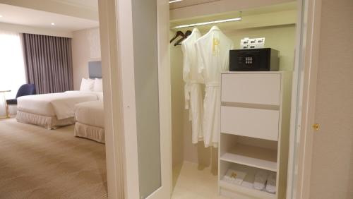a hotel room with a bed and a closet at Royce Hotel & Casino in Clark