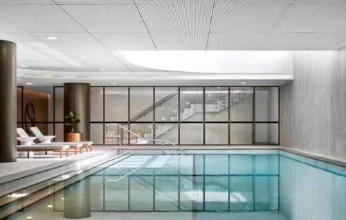 a swimming pool in a building with a building at Skygarden On The Glen in Glen Waverley