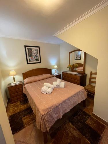 a bedroom with a bed with two towels on it at Fonte do Forno Villas in Afife
