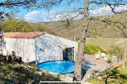 a house with a swimming pool in front of it at Superbe Villa en Provence 85 m2 in Puimichel