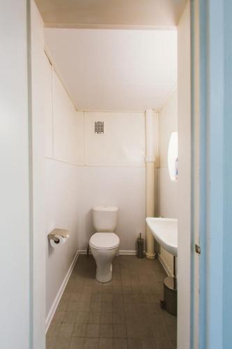 a small bathroom with a toilet and a sink at YH Lappeenranta in Lappeenranta
