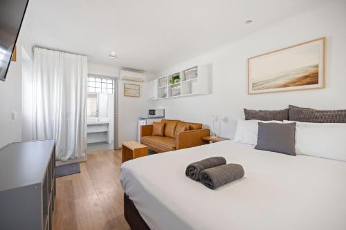 a bedroom with a large bed and a living room at Pet Room at Moody's in Blairgowrie