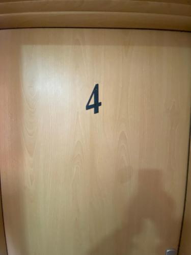 a clock with the number four on it at Ceka Apartments in Ulcinj