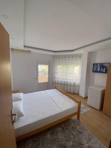 a bedroom with a large white bed in a room at Ceka Apartments in Ulcinj