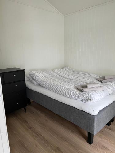 a bed in a room with a nightstand and a bed sidx sidx sidx sidx at Lofoten seaview in Ballstad