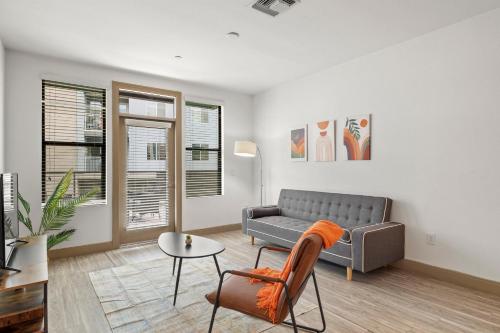 a living room with a couch and a table at Modern 2BR CozySuites on Town Lake waterfront 11 in Tempe