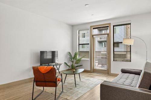 a living room with a couch and a tv at Modern 2BR CozySuites on Town Lake waterfront 11 in Tempe