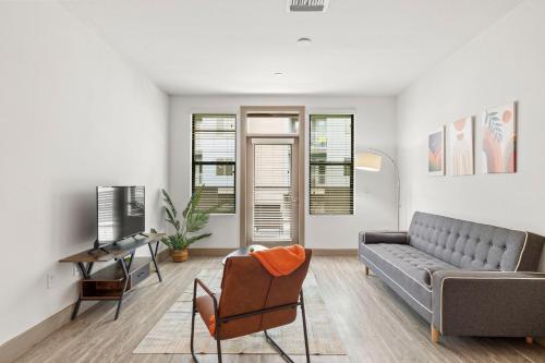 a living room with a couch and a table at Modern 2BR CozySuites on Town Lake waterfront 11 in Tempe