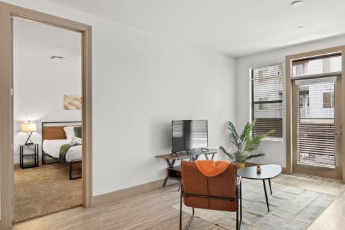 a living room with a mirror and a bedroom at Modern 2BR CozySuites on Town Lake waterfront 11 in Tempe