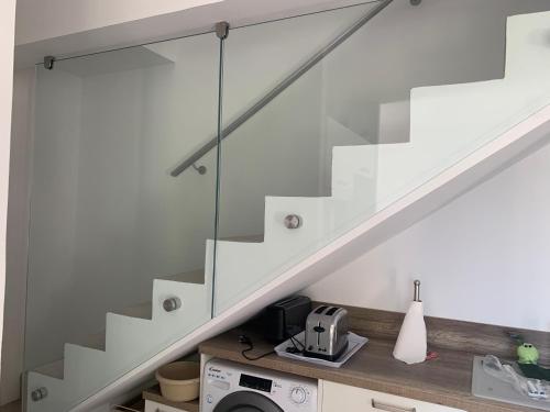 a staircase with glass railing in a house at Casa di Mare in San-Martino-di-Lota