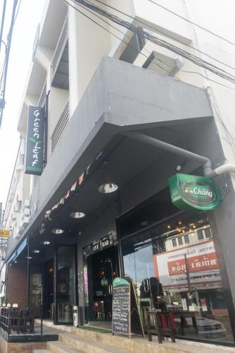 a store front of a restaurant with tables and chairs at Green Leaf Hostel in Phuket Town