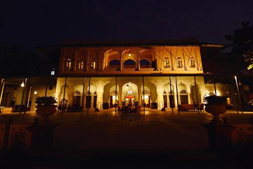 a large building at night with lights on it at Castle Kanota in Kānota