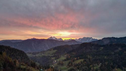 a sunset in the mountains with a red sky at Dwarfs cabin overlooking Julian Alps near Bled in Jesenice