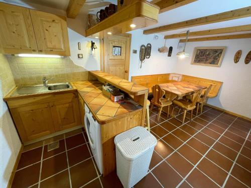 a kitchen with a sink and a table in it at Dwarfs cabin overlooking Julian Alps near Bled in Jesenice