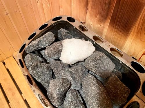 a basket full of rocks in a room at Dwarfs cabin overlooking Julian Alps near Bled in Jesenice