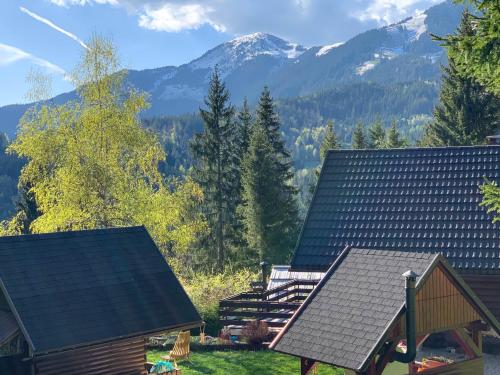 a view of a house with mountains in the background at Dwarfs cabin overlooking Julian Alps near Bled in Jesenice