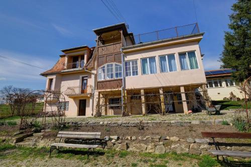a house on top of a stone wall at Elimheim in Cisnadioara