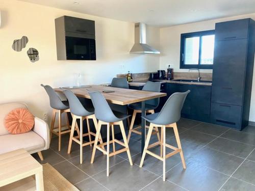 a kitchen with a large wooden table and chairs at Mas du Couchant in Suze-la-Rousse