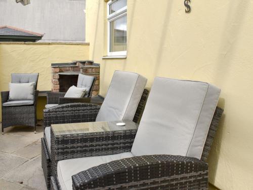 a group of wicker chairs sitting on a patio at Tramways in Carnbrea