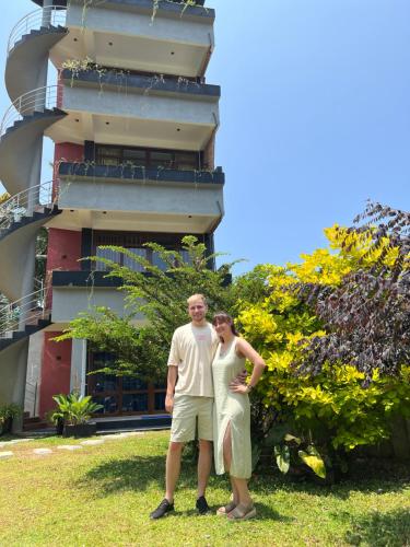 a man and a woman standing in front of a building at Kapaliya Unawatuna in Unawatuna