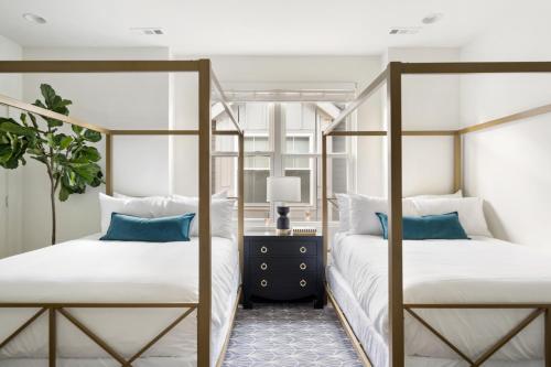 a bedroom with two bunk beds with blue pillows at The Hart Suites by AvantStay in Nashville